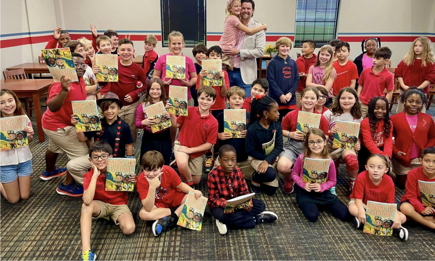 Children holding Energy for Everyone books in a classroom