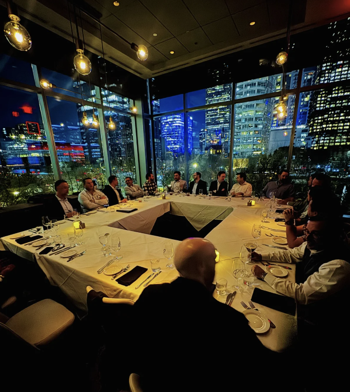 Crue Club roundtable dinner with city skyline
